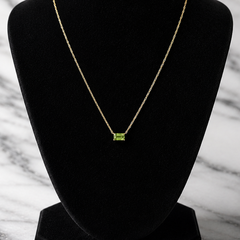 green peridot pendant on yellow gold chain