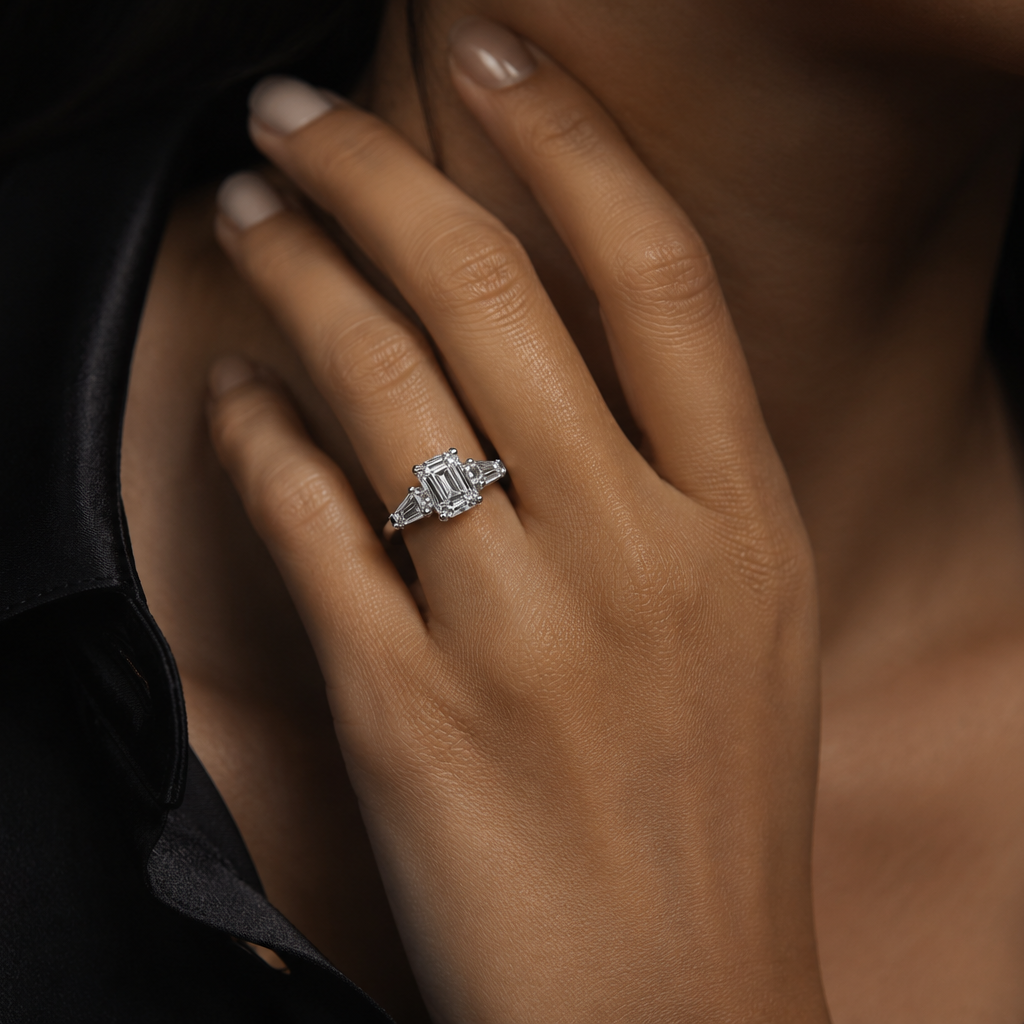 Close-up of a hand wearing a diamond ring with a dark background