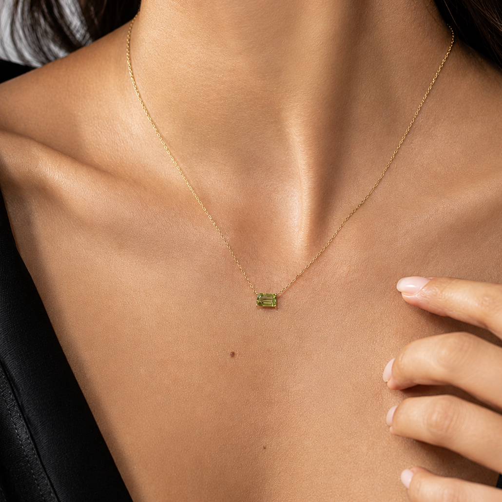 peridot pendant on yellow gold chain on model