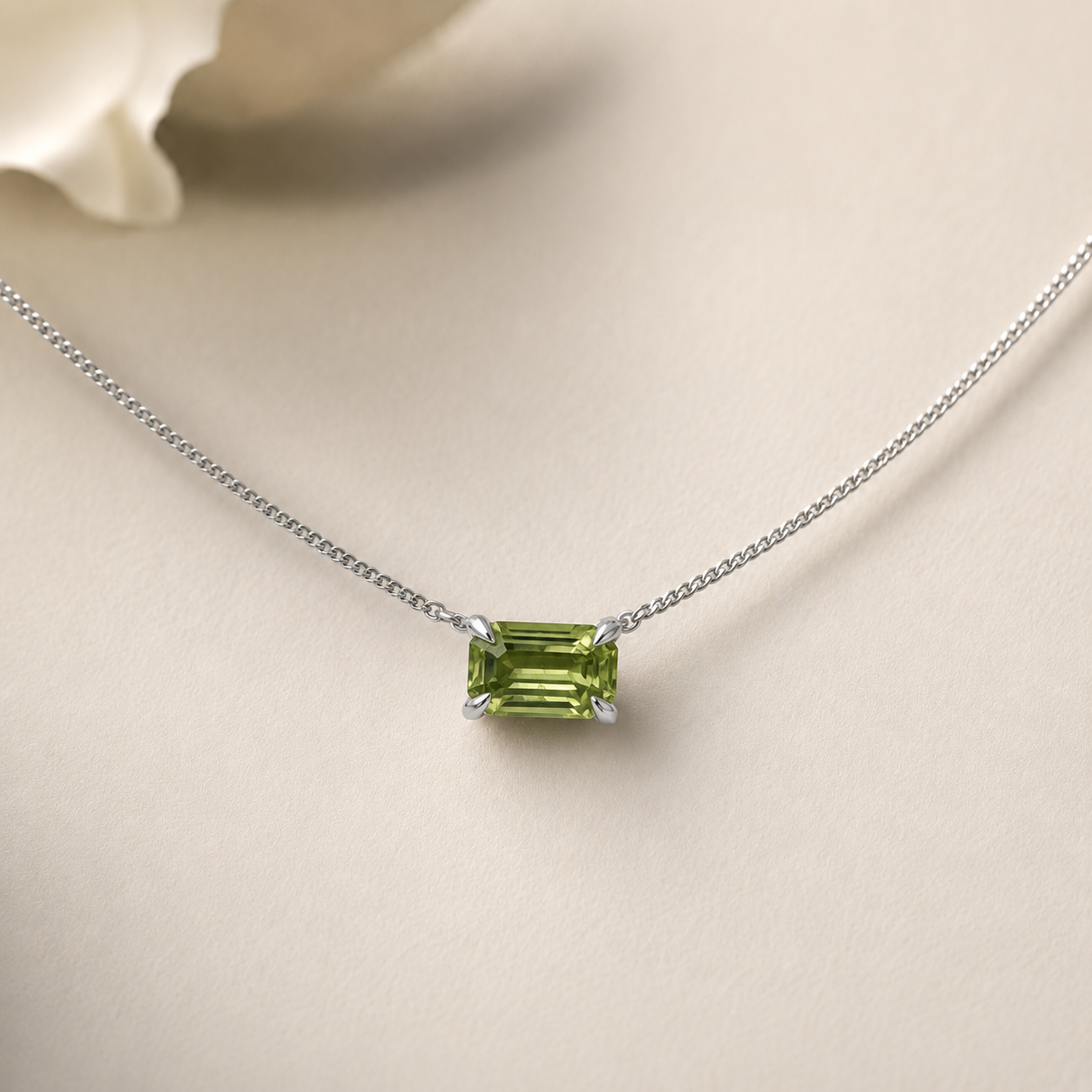Green gemstone necklace on a beige background
